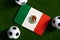 Flag of Mexico. Football balls on a green lawn