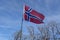 Flag of Norway flown on blue sky