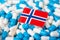 Flag of Norway on piles of pills