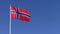 Flag of Norway on pole against blue sky