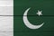 Flag of Pakistan on wooden wall background. Grunge Pakistani flag texture.