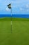 Flag and Pin on Hole Overlooking Pacific Ocean