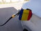 Flag of Romania on the car`s fuel tank filler flap. Petrol station. Fueling car at a gas station