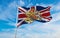 flag of Royal Arms of England on United Kingdom at cloudy sky background on sunset, panoramic view. united kingdom of great