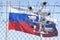 Flag of Russia behind barbed wire fence and cctv cameras. Concept of sanctions, dictatorship, discrimination and violation of