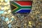 Flag of South Africa on the laptop screen and many bitcoins. National cryptocurrency regulations and crypto mining