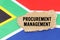 On the flag of South Africa lies a cardboard box with the inscription- PROCUREMENT MANAGEMENT