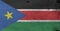 Flag of South Sudan on wooden plate background. Grunge South Sudan flag texture.