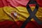 Flag of spain with black mourning ribbon