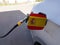 Flag of Spain on the car`s fuel tank filler flap. Petrol station. Fueling car at a gas station