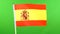 Flag of Spain on flagpole on green background. Spanish Flag waving in wind.