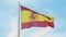 Flag of Spain. Red and yellow Spanish flag waving in the wind on a flagpole against the clear blue sky.