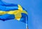 Flag of Sweden waving in the wind on a blue sky