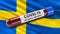 Flag of Sweden waving in the wind with a positive Covid-19 blood test tube. 3D illustration concept.