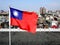 The flag of Taiwan flutters in the sky. 26th floor rooftop cityscape in Kaohsiung