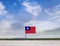 Flag of Taiwan with vast meadow and blue sky behind it.