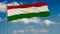 Flag of Tajikistan against background of clouds floating on the blue sky