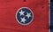 Flag of Tennessee on wooden plate background. Grunge Tennessee flag texture.