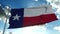 Flag of Texas waving in the wind against deep beautiful clouds sky