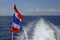 Flag of Thailand waving in the wind on the ferry