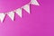 Flag triangular decorativ, party garland over colorful pink background. Christmas party, birthday mockup with copy space