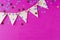 Flag triangular decorativ, party garland over colorful pink background. Christmas party, birthday mockup with copy space