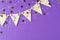 Flag triangular decorativ, party garland over colorful purple background. Christmas party, birthday mockup with copy space