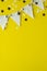 Flag triangular decorativ, party garland over colorful yellow background. Christmas party, birthday mockup with copy space