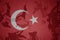 flag of turkey on the khaki texture . military concept