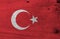 Flag of Turkey on wooden plate background. Grunge Turkish flag texture.