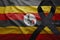 Flag of uganda with black mourning ribbon
