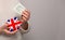 Flag of UK on money bank in English woman hands. Dotations, pension fund, poverty, wealth, retirement concept