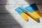 The flag of Ukraine is blue and yellow on the background of wooden figured boards.