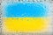 Flag of Ukraine. Ukrainian flag on the background of water drops. Flag with raindrops. Splashes on glass