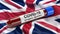 Flag of the United Kingdom waving in the wind with a positive Covid-19 blood test tube. 3D illustration concept.