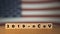 Flag of USA with outbreak deadly coronavirus covid-19 in background. Wooden blocks with inscription 2019-nCov. USA flag