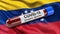 Flag of Venezuela waving in the wind with a positive Covid-19 blood test tube. 3D illustration concept.