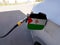 Flag of West Sahara on the car`s fuel tank filler flap. Petrol station. Fueling car at a gas station