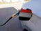 Flag of Yemen on the car`s fuel tank filler flap. Petrol station. Fueling car at a gas station