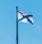 Flagpole with St. Andrew`s flag against the blue, cloudless sky