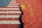 Flags of America and China on asphalt are separated by a crack.