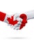 Flags Canada, Japan countries, partnership friendship handshake concept.