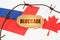 On the flags of Canada and Russia lies a cardboard plate with the inscription - Blockade