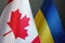 Flags of Canada and Ukraine as a symbol of cooperation.