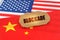 On the flags of China and the United States lies a cardboard plate with the inscription - Blockade