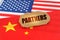 On the flags of China and the United States lies a cardboard plate with the inscription - Partners