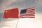 Flags of China and USA waving with cloudy blue sky background, 3D redering United States of America, Chinese Communist Party CCP