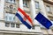 Flags of Croatia and European Union against the facade of Croatian Government building in historic Zagreb