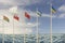 Flags of different countries of the world fluttering in the wind, against the blue sky with copy space