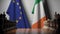 Flags of the EU and the Republic of Ireland behind chess board. The first pawn moves in the beginning of the game